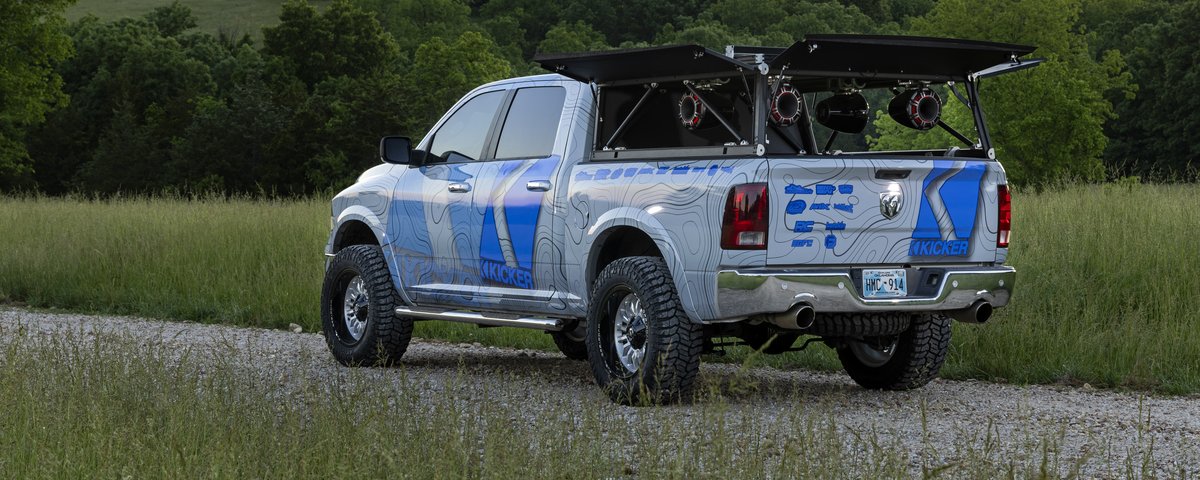 Ram rear three-quarter view with the truck-bed audio system raised