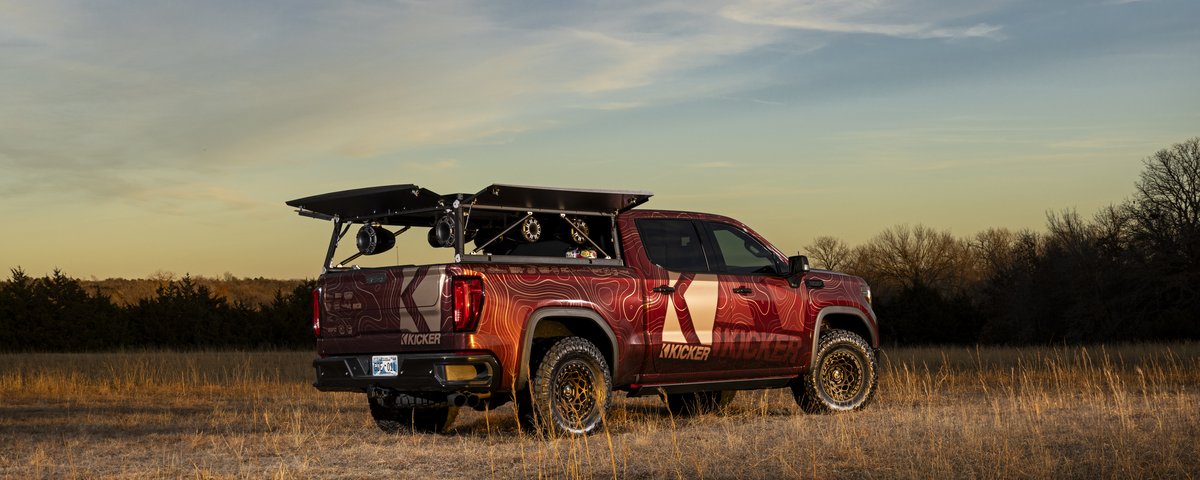GMC Sierra rear three-quarter view at sunset