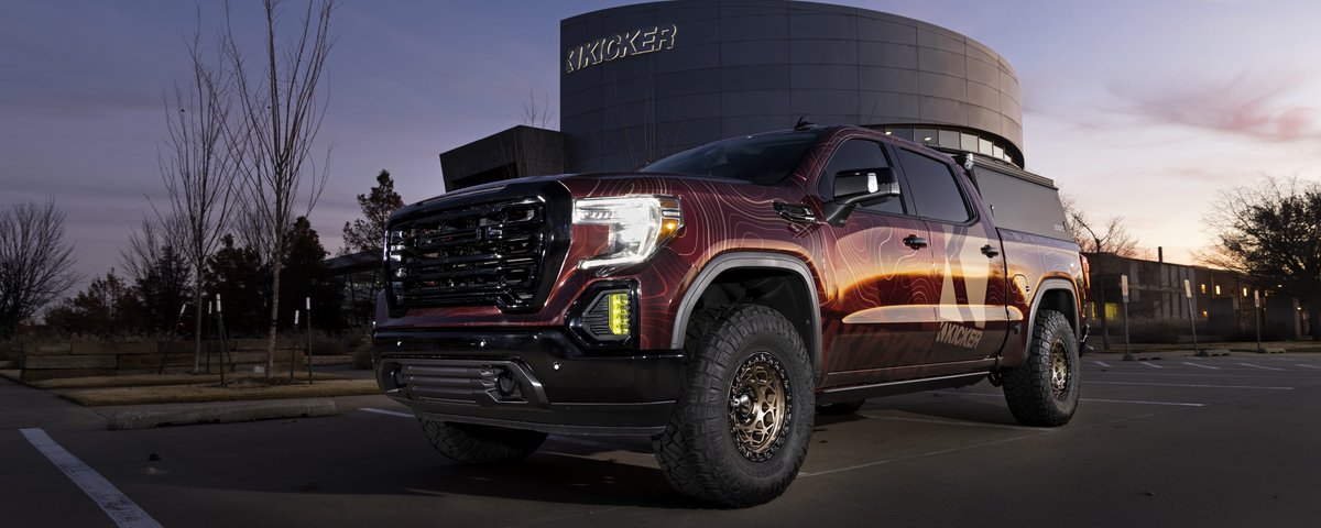 GMC Sierra front three-quarter view outside KICKER headquarters