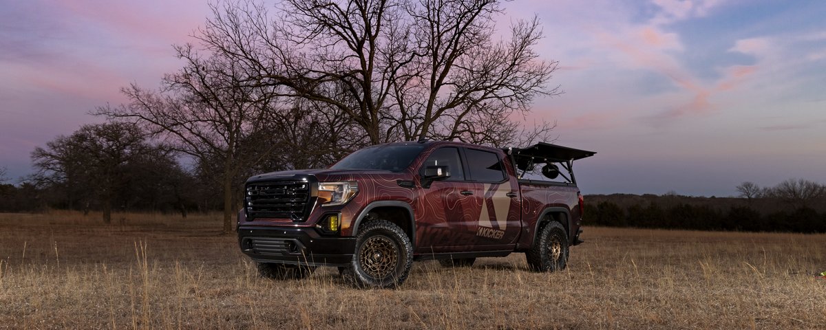 GMC Sierra front three-quarter view in a field