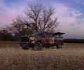 GMC Sierra front three-quarter view in a field