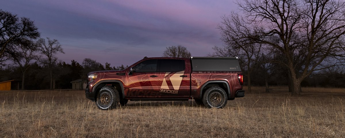 GMC Sierra side profile in a field