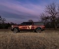 GMC Sierra side profile in a field