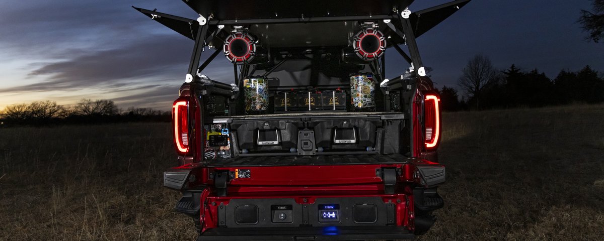 GMC Sierra rear audio system illuminated at dusk