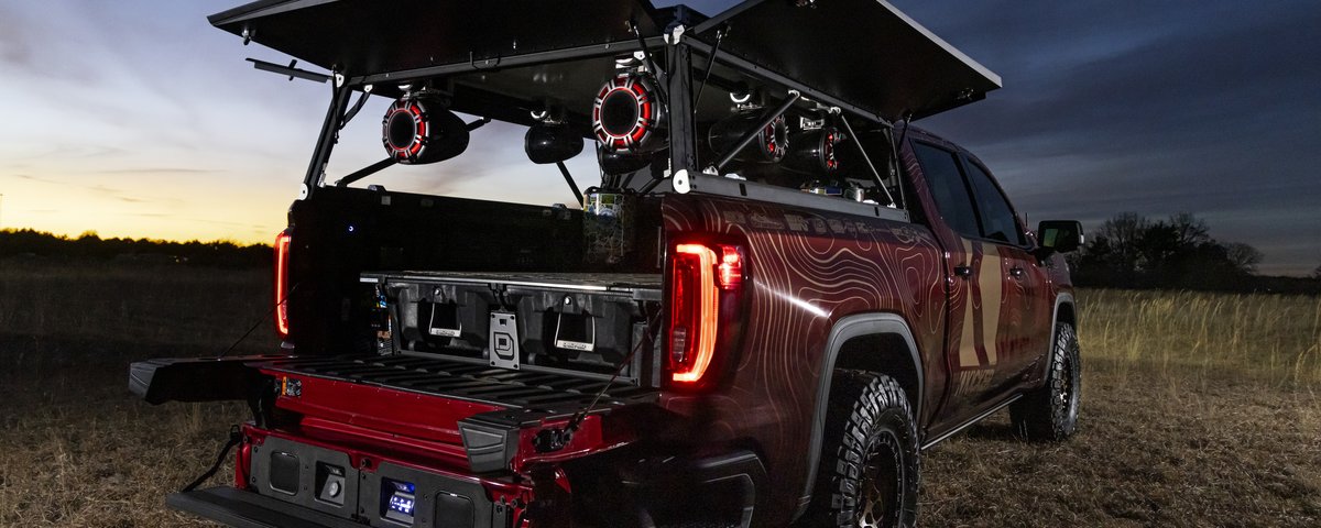 GMC Sierra rear three-quarter view at dusk