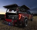 GMC Sierra rear three-quarter view at dusk