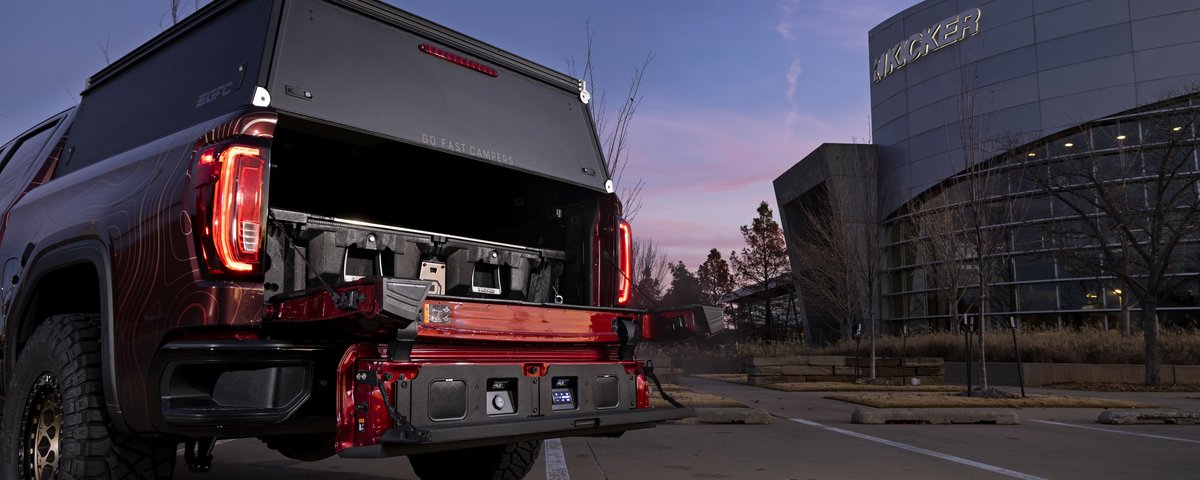 GMC Sierra rear view with the truck-bed audio system open