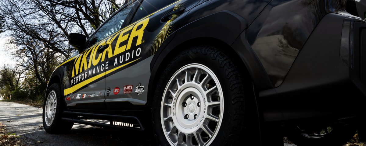 Low side view of the Subaru CrossTrek wheel and KICKER graphics