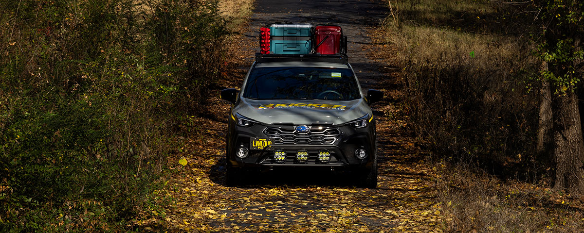 Subaru CrossTrek front view on a wooded trail