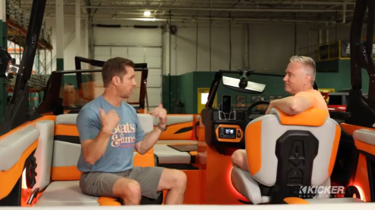 KICKER representatives seated inside the Oklahoma State University Wake Team Axis boat