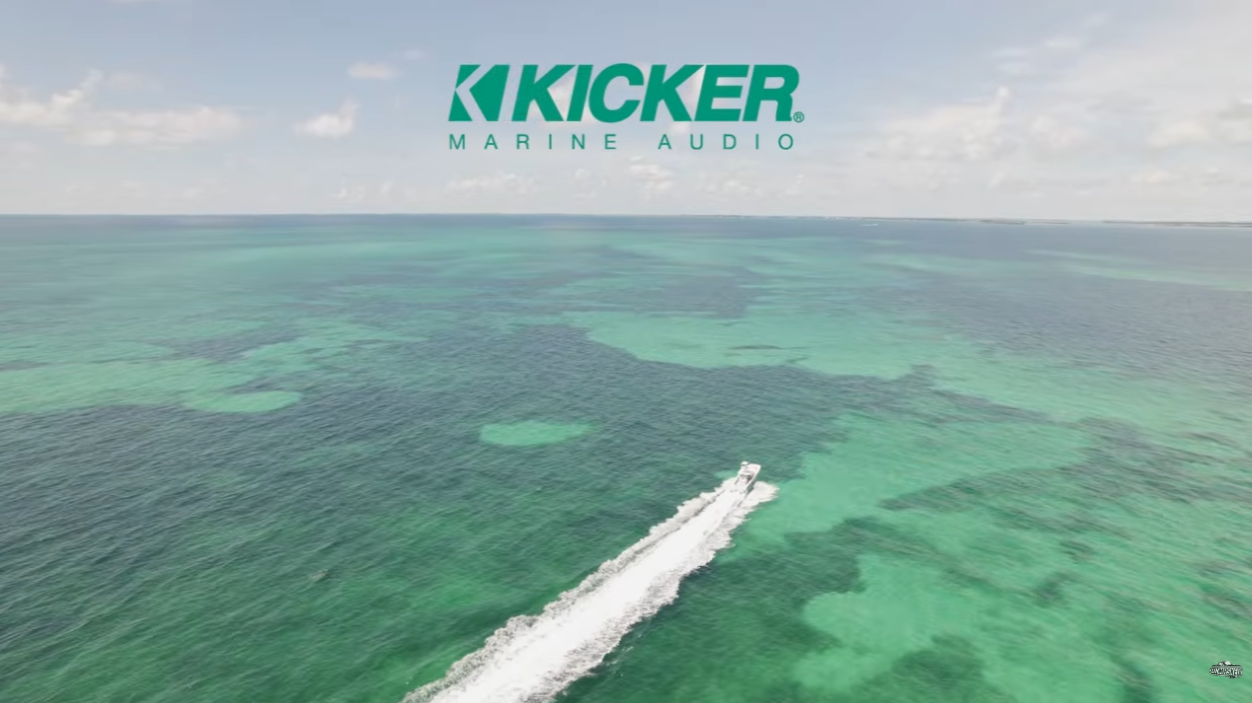Vice Versa speeding across turquoise water in the Florida Keys beneath KICKER Marine Audio branding